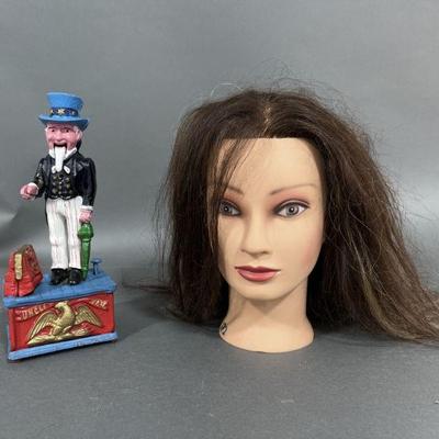 Lot 228 | Cast Iron Uncle Sam Bank & Mannequin Head

