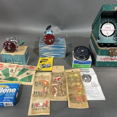 Lot 389 | New Old Stock Reels, Hooks, Line & Fish Loktor

