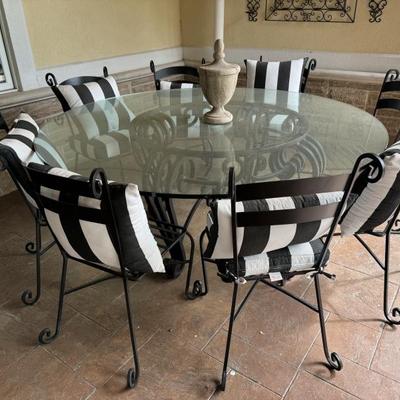 Round glass top with Wrought iron base and 8 chairs 