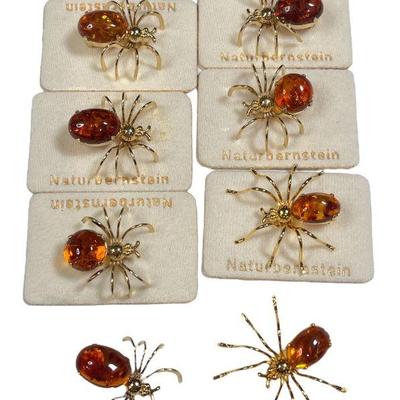 Eight Gold Plated Amber Spider Brooches