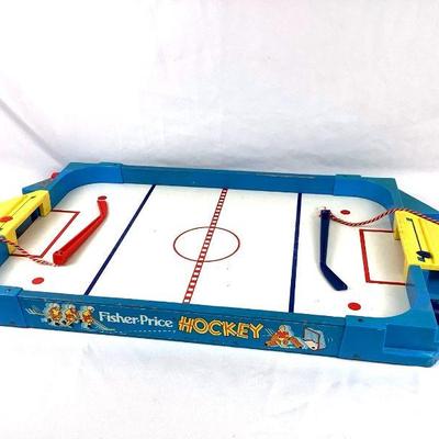 GRLI213 Vintage Fisher Price Hockey Table Game	Vintage 1974 Fisher Price Hockey table game. Comes with 2 pucks and hockey sticks. 
