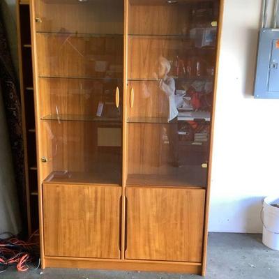 TOSH305 Teak Wood Danish Style Display Cabinet	Beautiful lighted  teak wood cabinet with glass shelves.  There are 2 shelves below on...
