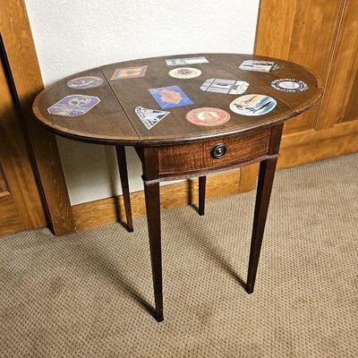  Antique Mahogany Drop Leaf End Table with Vintage Travel Stickers Decorating the Top