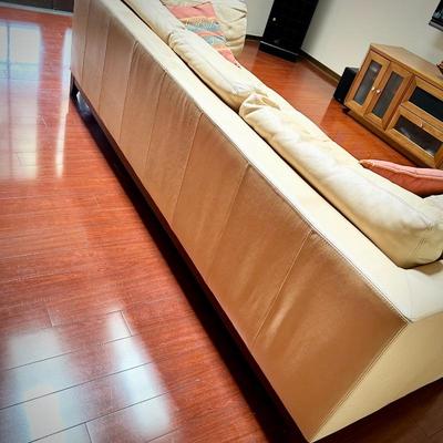 Pale yellow leather tuxedo-style sofa - finished on all sides