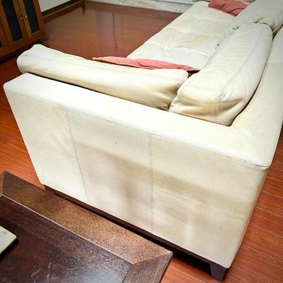Pale yellow leather tuxedo-style sofa - finished on all sides