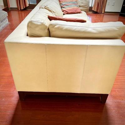Pale yellow leather tuxedo-style sofa - finished on all sides