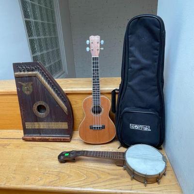 Antique zither, Cordoba concert ukelele, and miniature/child's banjo 