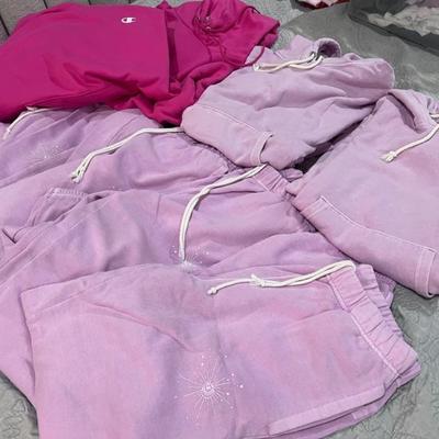 A bunch of champion sweatsuits all sizes
