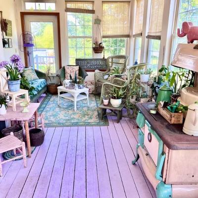 Wicker patio furniture, woodburning, cookstove, plants, table and chairs