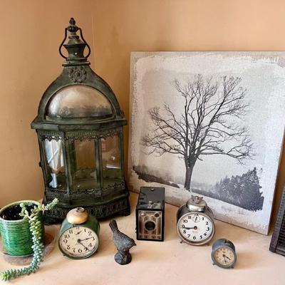 Lantern, vintage clocks, camera, and decor