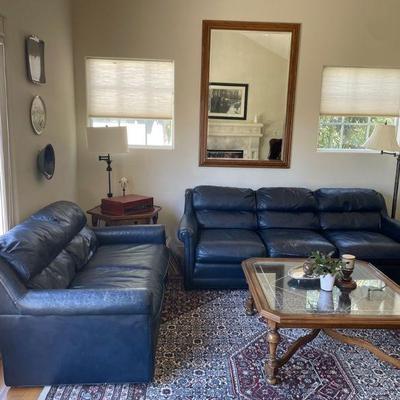 Leather sofa, love seat coffee table, mirror, side table, wool rug.