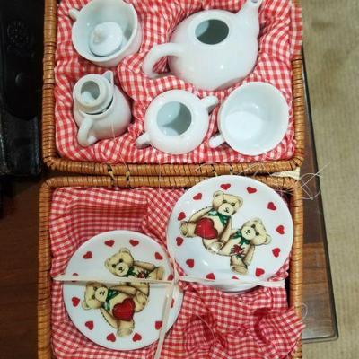 Cute little child's tea set in basket