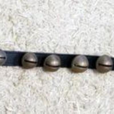 1021	NICE STRAND OF BRASS SLEIGH BELLS ON 93 IN LEATHER STRAP, 26 CRADUATED SIZE BELLS
