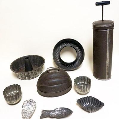 1017	GROUP OF PRIMITIVE TIN KITCHEN ITEMS INCLUDING FOOD MOLDS & TIN MAYONNAISE MIXER
