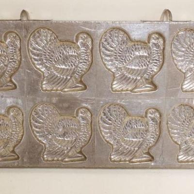 1002	ANTIQUE CHOCOLATE TURKEY MOLD MARKED NEW YORK, APPROXIMATELY 12 IN X 6 1/2 IN
