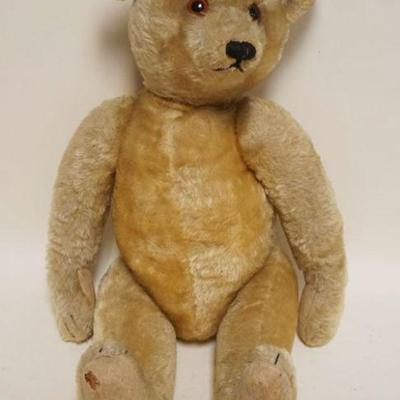 1066	LARGE ANTIQUE TEDDY BEAR W/JOINTED ARMS & HEAD W/GLASS EYES, APPROXIMATELY 23 IN HIGH
