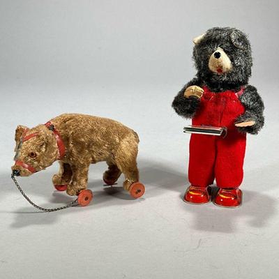 (2pc) Vintage Bear Toys | Including a Japanese wind up tin toy of a grey bear holding a book of animals and a pull along bear on wheels....