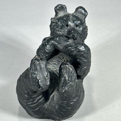 PLAYFUL BEAR FIGURINE | Ceramic bear figurine showing bear on back eating fish. - l. 7 x w. 4.5 x h. 5.5 in

