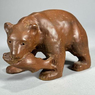 CARVED WOOD BEAR | Hand-carved wood bear figurine with fish in its mouth. - l. 7.5 x w. 3.75 x h. 5 in

