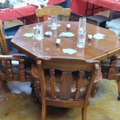 Octagonal table with 4 chairs, has a leaf