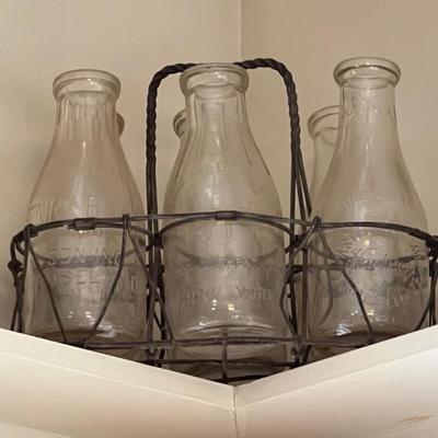 Glass milk bottles in metal delivery carrier