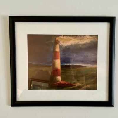 Framed print of a lighthouse scene by artist Joe Wilson. 