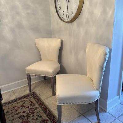 Pair of white leather chairs with gray design back. $100