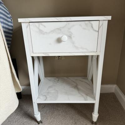 Two contemporary faux marble finish bedside tables.