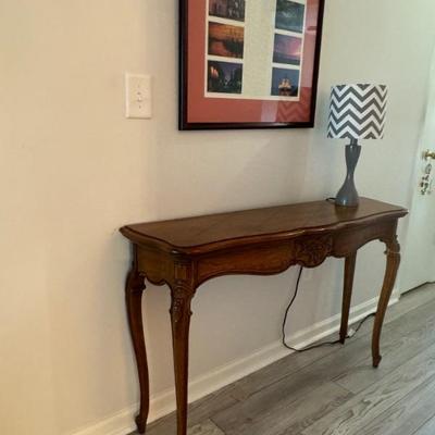  Solid wood traditional foyer/console table. Measures 48”wide x 13” deep x 30” tall. $120