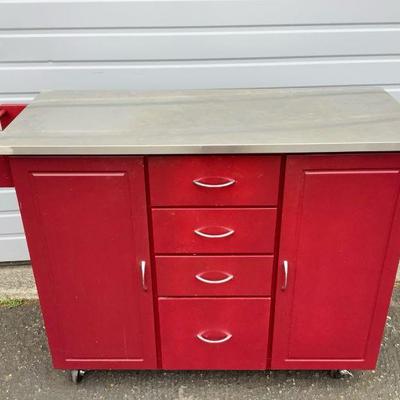 DEJE604 Kitchen Island Cart	This lot includes a beautiful red kitchen island cart with locking wheels, multi-purpose cross bar, easy...