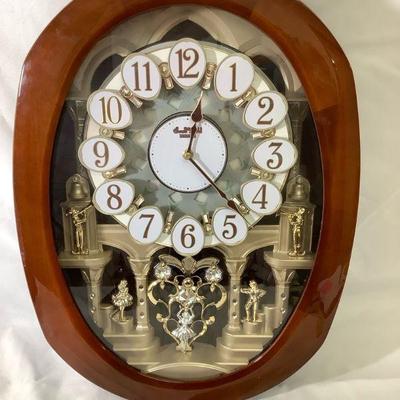 DEJE308 Grand Encore Small World Clock	Clock plays:   6 Rock N Roll, 6 Classics and 6 Xmas tunes.  Clock is approximately 22" Tall x...