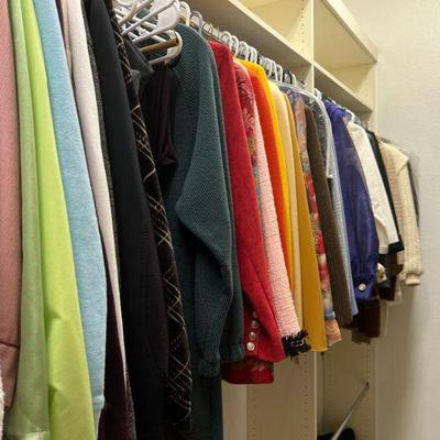 Full walk-in closet of women's clothing, shoes and bags