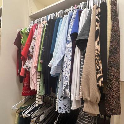 Full walk-in closet of women's clothing, shoes and bags