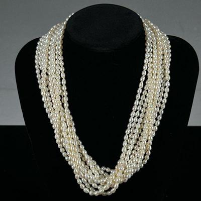 BAROQUE PEARL & STERLING NECKLACE | Designed as a 10-string 4.4mm baroque Pearl necklace with sterling silver clasp. - l. 18 in

