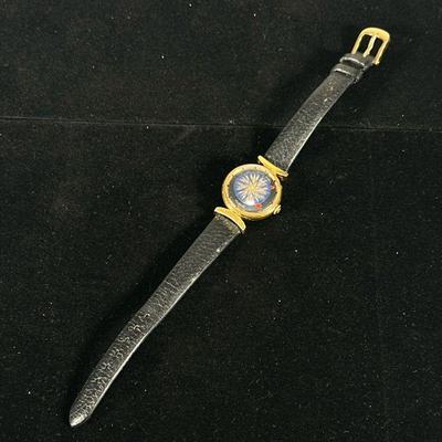 ERNEST BOREL COCKTAIL KALEIDOSCOPE WATCH | Featuring black dial with blue rotating kaleidoscope center and clear back with leather band.

