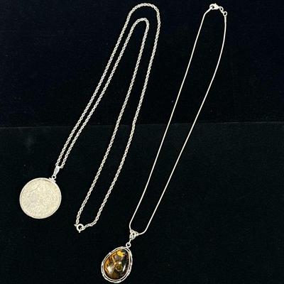STERLING NECKLACES WITH PENDANTS | Designed as a sterling silver necklace with mounted 1921 Morgan silver dollar pendant chain marked...