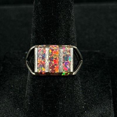 OPAL & STERLING SILVER RING | Designed as a (tested to) sterling silver ring with 3 inlaid rectangular cut opals, size 7, total...