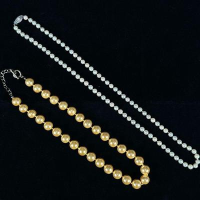 (2pc) PEARL NECKLACES | Designed as a sting of 12.4mm champagne pearls, and string of 6.4mm pearls with 14K white gold clasp. - l. 26 in...