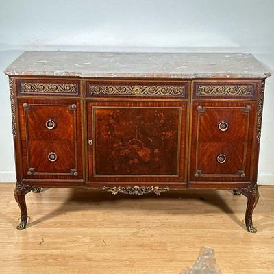 LOUIS XVI STYLE DRESSER | Carved wood dresser with floral & vine work brass accents having shaped marble top, 3 top drawers over...