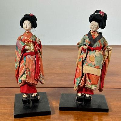 (2pc) PAIR MOUNTED JAPANESE DOLLS | Pair of Japanese geisha dolls on wood stand. - h. 7 in

