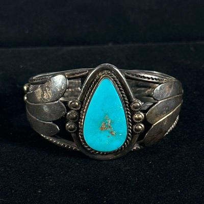 TURQUOISE & STERLING SILVER BRACELET | Designed as a sterling silver open bracelet with mounted teardrop turquoise; total weight:...