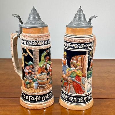 (2pc) PAIR LARGE GERMAN BEER STEINS | Pair of large German beer steins with bard relief. - h. 13.5 x dia. 5 in

