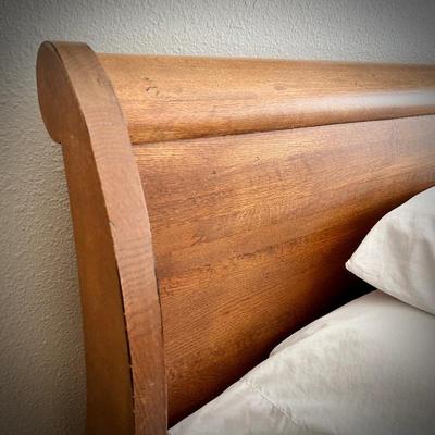 Queen-size sleigh bed with hidden cedar drawer