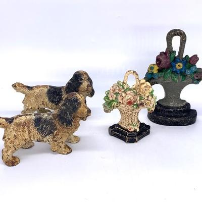 Left: 2 antique solid body Hubley spaniel door stops in original paint
Right: Antique floral basket door stops in orig. paint
