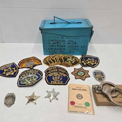 #1944 • Blue Ammo Can with (19) Police Patches, (3) Sheriff Badges and more
