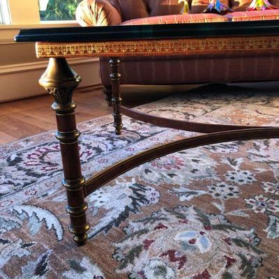 Showing close-up of metal coffee table with brass accents