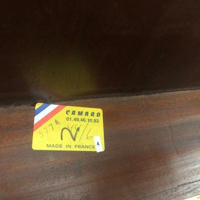 Label on underside of dining table.