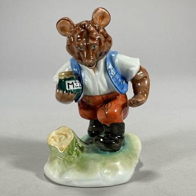 Herend Bear Figure | Porcelain Herend bear holding a jar of Mez, marked on the bottom. - l. 3.5 x h. 5.5 in

