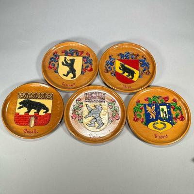 (5pc) Heraldic Wood Plates | Carved and painted wood plates depicting the cost of arms of different cities with bears, stamped Argentina,...