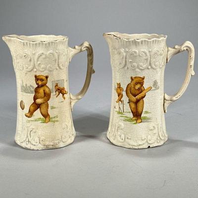(2pc) English Bear Pitchers | English sculpted porcelain pitchers each decorated with scenes of bears engaged in sporting activities,...